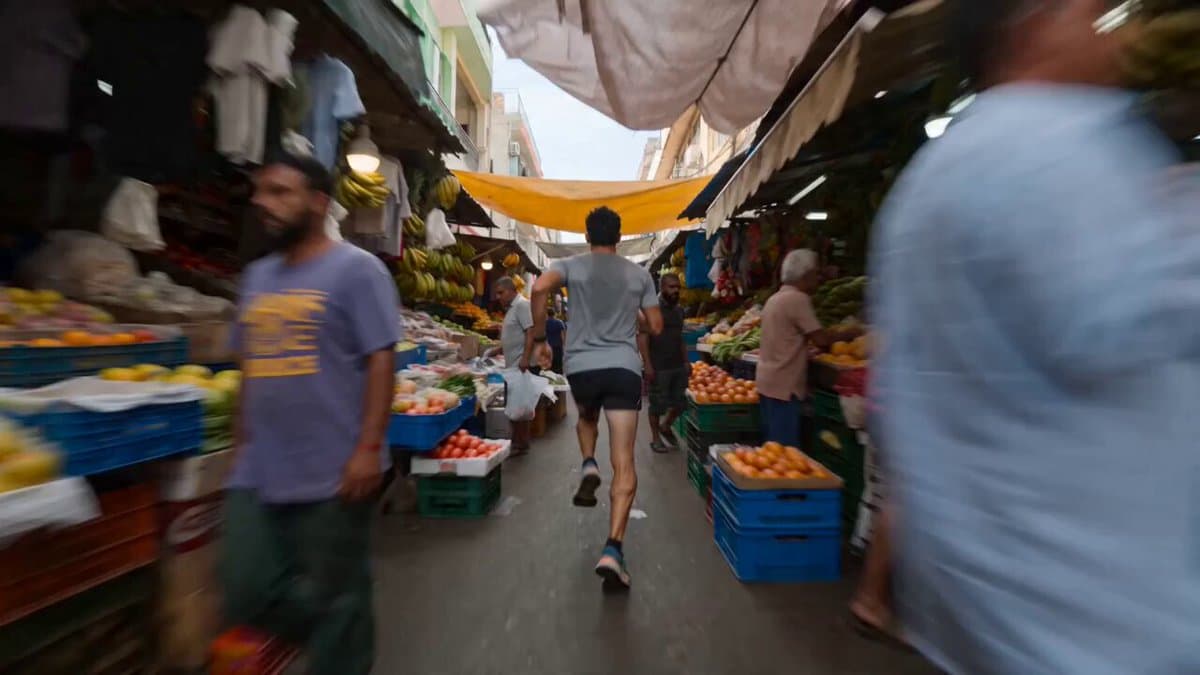 Runner Sprinting Through Crowded Market Video